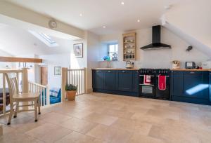 a kitchen with blue cabinets and a stove at Bryn Mawr in Eglwys-Fâch