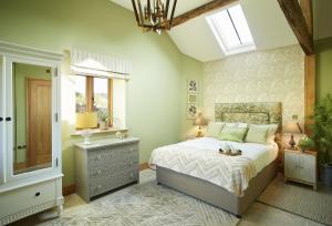 a bedroom with a bed and a window at The Cart Shed Shropshire in Downton