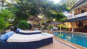 a resort with two beds next to a swimming pool at Mami Wata House in Kwale