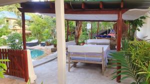 a patio with a table and chairs and a pool at Mami Wata House in Kwale
