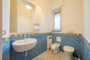 a bathroom with a sink and a toilet at Genoa Sturla Comfy Apartment in Genova