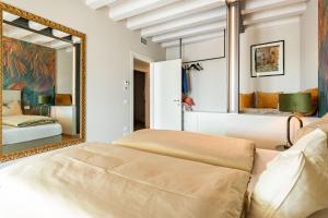 a bedroom with a large mirror and a bed at Cavalino Boutiquehouse in Cavaion Veronese +27 photos