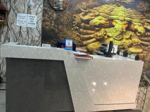 a counter in a store with a painting on the wall at THE Flight path Unit By Urban Luxury Delhi Airport in New Delhi