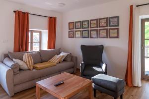 a living room with a couch and a chair at Villa Richterberg with Sauna & Hot Tub in Slovenj Gradec