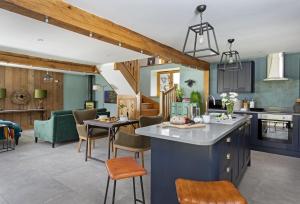 a kitchen and living room with blue cabinets at The Timber Barn in Downton