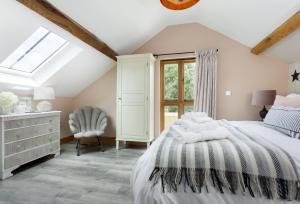 a bedroom with a bed and a window at The Timber Barn in Downton