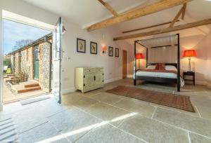 a bedroom with a bed and a large window at Bodney Lodge in Bodney