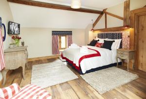 a bedroom with a large bed in a room at The Stone Barn in Downton