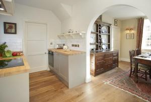 a kitchen with an archway and a table in a room at The Green in Coneysthorpe