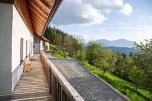 a balcony of a house with a view of the mountains at Villa Richterberg with Sauna & Hot Tub in Slovenj Gradec