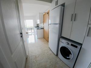 a kitchen with a refrigerator and a washing machine at Doğa Apart in Ortaca