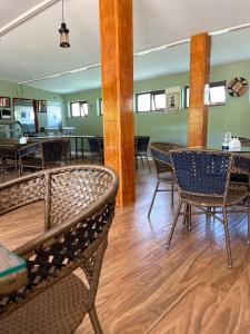 a dining room with tables and chairs at Zebi Ecolodge in Hoima