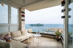 a living room with a couch and a view of the ocean at Luxury Apartment Libertas in Dubrovnik
