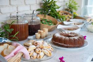 a table topped with cakes and pastries on plates at Bronze Hotel in Oludeniz
