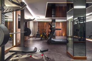 a gym with exercise equipment in a room at My Story Gdynia Hotel in Gdynia