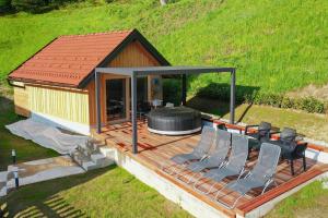 a gazebo with chairs and a grill on a deck at Villa Richterberg with Sauna & Hot Tub in Slovenj Gradec +42 photos
