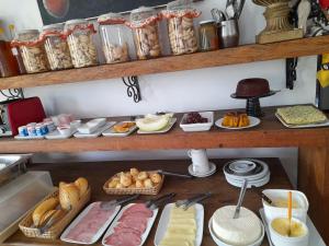 a shelf filled with lots of different types of food at Pouso do Manu in Tiradentes