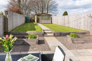 a garden with a wooden fence and a gazebo at Cottage - Sleeps 3 hot tub & pet friendly in Carlisle +10 photos