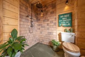 a bathroom with a toilet and a shower with tiles at Olive Tree House in Chalvington