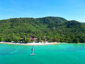 an island in the ocean with a boat in the water at Cruiser Island By Swiss-Belhotel in Ko Lone