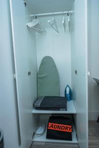a room with a shelf with a laptop on it at SLS VACATION STAY in Kent