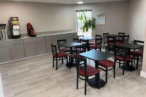 a restaurant with tables and chairs in a room at Days Inn by Wyndham Cincinnati East in Cherry Grove