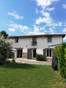 a white house with a yard in front of it at GITE LA BLANCHE LONGERE in Compertrix