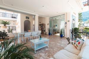 a living room with a couch and a table at Bronze Hotel in Oludeniz