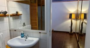 a bathroom with a sink and a mirror at Quinta da Meia Eira in Horta +46 photos