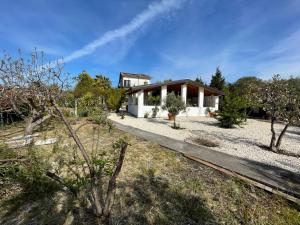 a house in the middle of a field with trees at Etna Petit Relais in Nicolosi