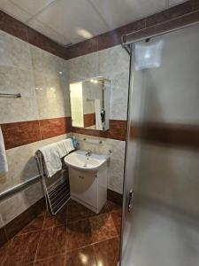 a bathroom with a sink and a shower at Apartment Fort Noks in Sveti Vlas