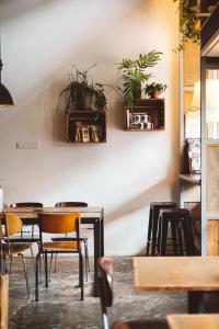 a restaurant with tables and chairs and plants on the wall at Hotel Unplugged in Rotterdam