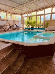 a large swimming pool with stairs leading into a house at Hotel Murter in Murter