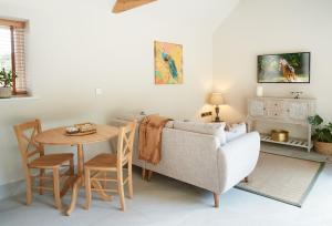 a living room with a couch and a table at Woodland Retreat in Burton upon Trent