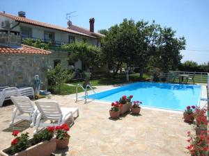 a villa with a swimming pool and a house at Apartments Fičur with Swimming Pool & Grill, Portorož in Portorož