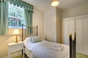 a bedroom with a bed and a window at Eslington Lodge in Alnwick