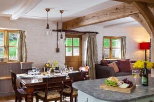 a kitchen and dining room with a table and chairs at Stone House in Leominster