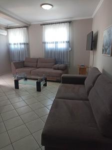 a living room with two couches and a tv at Evangelia in Karfas