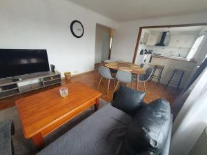 a living room with a couch and a table at Maison à Poitiers - Futuroscope in Poitiers