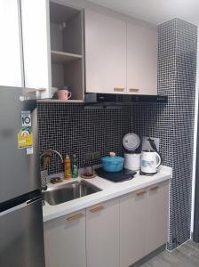 a kitchen with white cabinets and a sink at Apartments in Star Bay with sea view in Sihanoukville