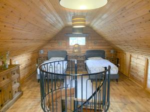 a room with two beds in a log cabin at Chalet 1 in Torcastle