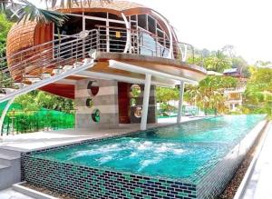 a house with a swimming pool with a spiral staircase at Emerald Terrace Condo 42- 1 Bed Pool in Patong Beach