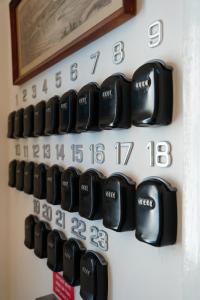 a bunch of black clocks on a wall at The Maltese Sun in Sliema