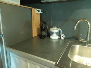 a kitchen counter with a sink and a coffee maker at La Gándara Casa Rural in San Justo de Cabanillas