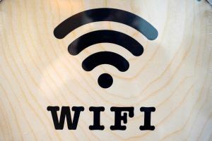 a wooden sign with an wifi symbol on it at The Maltese Sun in Sliema