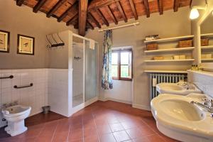 a bathroom with two sinks and a toilet at Villa Bellostare by PosarelliVillas in Cantagrillo +47 photos