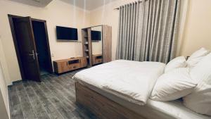 Ένα ή περισσότερα κρεβάτια σε δωμάτιο στο Altunyan Hotel