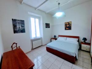 a bedroom with a bed and a table in it at Puzzle al Mare in Follonica