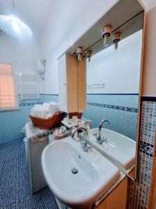 a bathroom with a sink and a mirror at Puzzle al Mare in Follonica