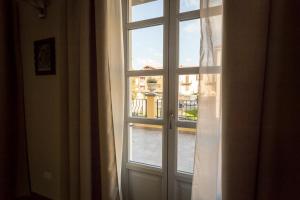 a window with a view of a city at Hotel Monteverde in Acqui Terme